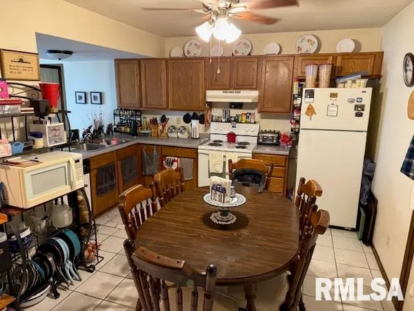 a kitchen with a dining table and chairs