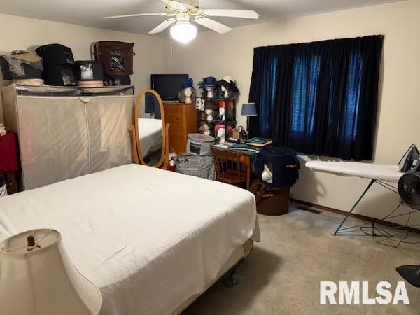 a bed room with a bed window and a mirror