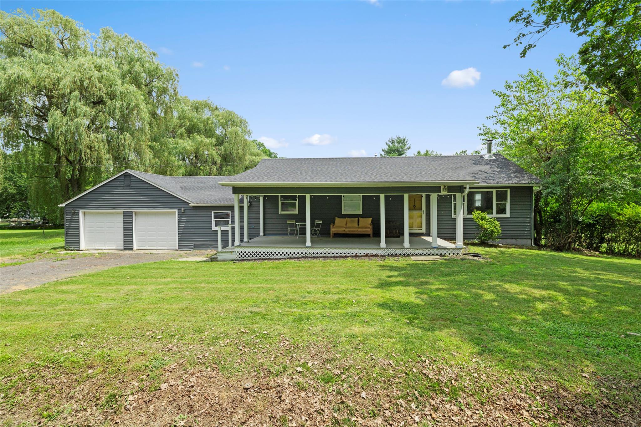 a front view of a house with a garden