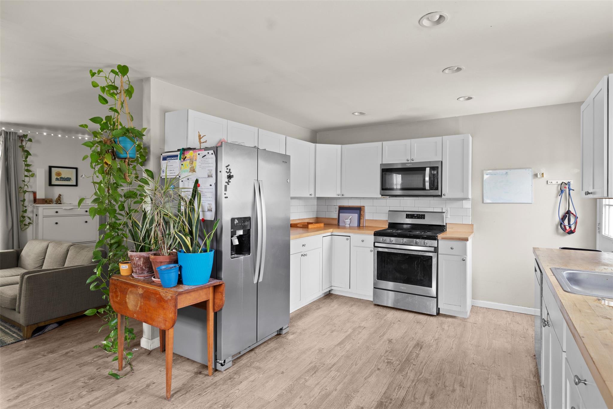 44 Woods Road Tivoli, NY 12583 - Photo 12 of 25 a kitchen with stainless steel appliances a stove a refrigerator a sink a stove a dining table and chairs