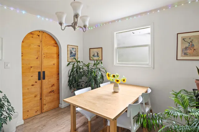 a view of a dining room with a table and chairs