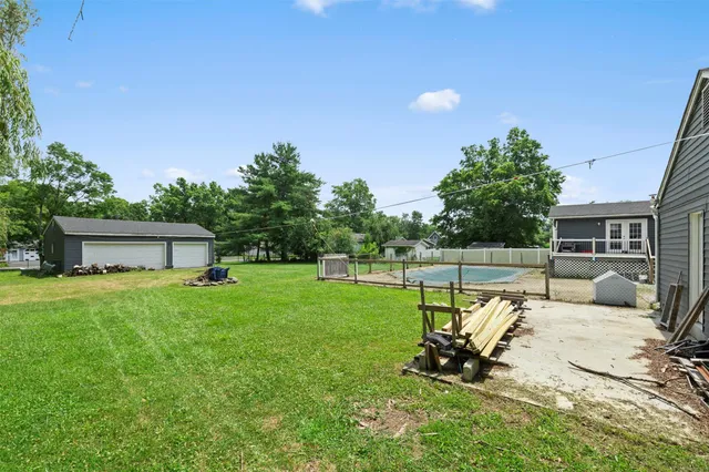 a view of a backyard with a sitting area and garden