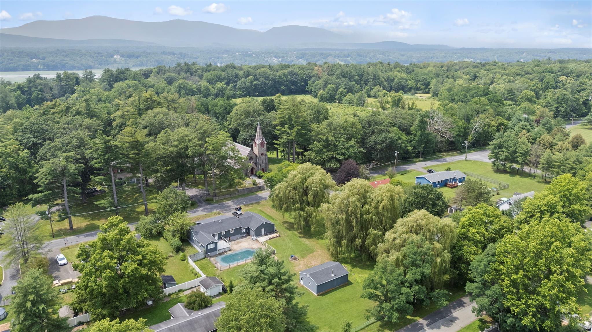44 Woods Road Tivoli, NY 12583 - Photo 24 of 25 an aerial view of a city with lots of residential buildings and mountain view in back
