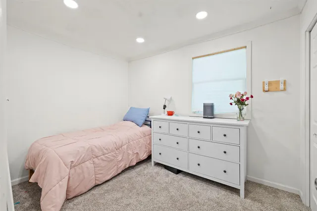 a bedroom with a bed and a dresser