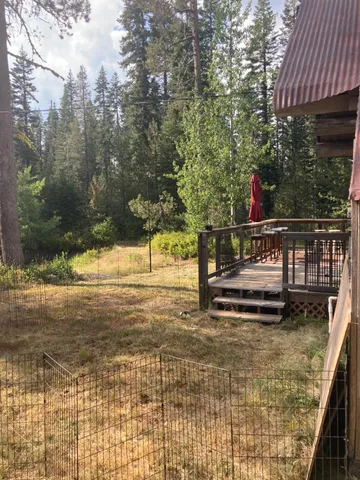 a view of wooden house with a backyard