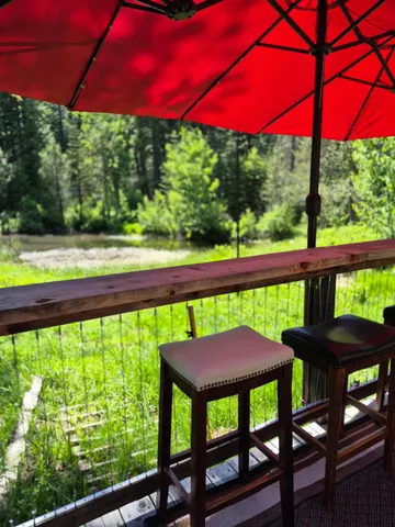 a view of a swimming pool with a table and chairs under an umbrella