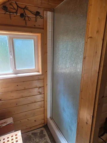 a bathroom with a granite countertop toilet sink and mirror