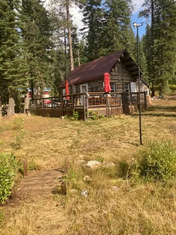 a view of swimming pool with a bench and trees
