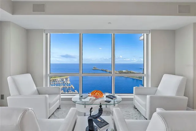 a view of a dining room with furniture water view and kitchen view