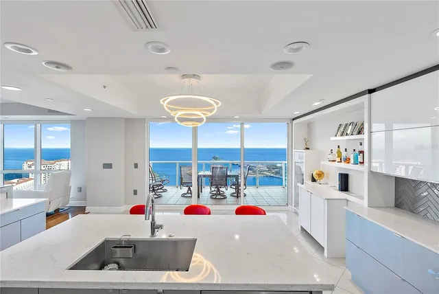 a kitchen with stainless steel appliances granite countertop a sink and a refrigerator