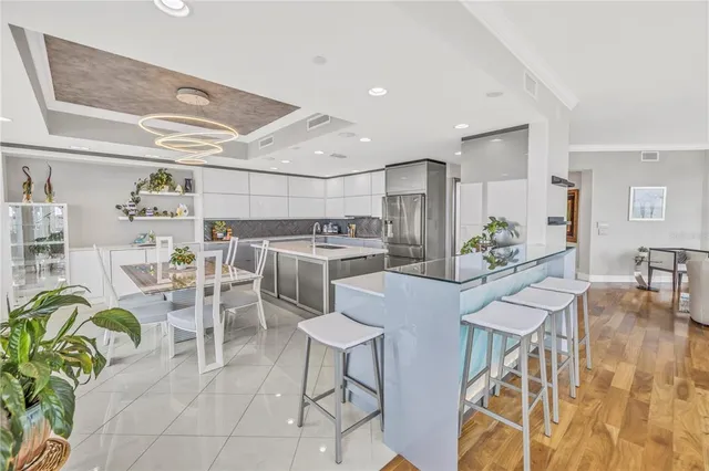 a kitchen with stainless steel appliances granite countertop a refrigerator and a sink