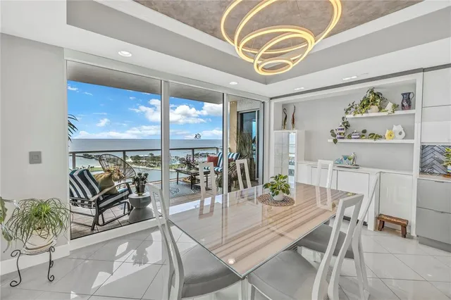 a view of a city from a dining room with furniture