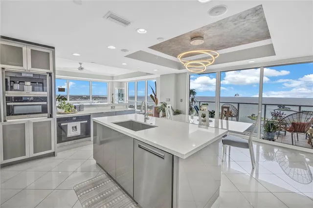 a bedroom with a balcony a bed and a flat screen tv