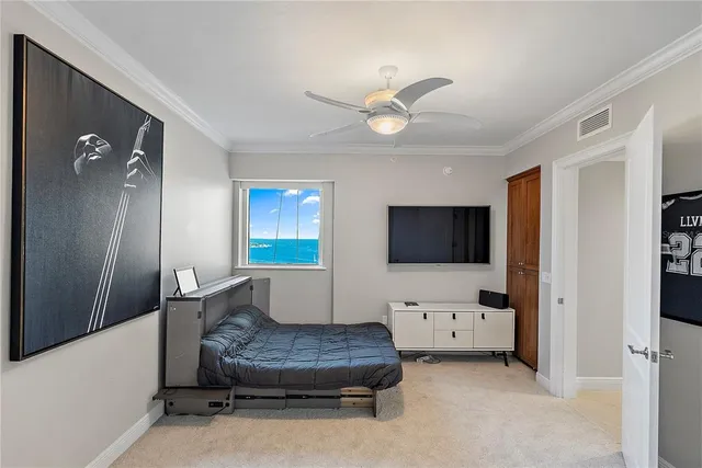 a living room with couches and kitchen view with wooden floor