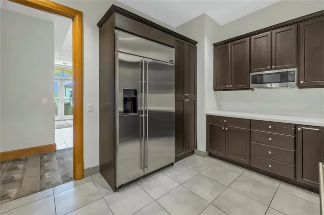 a view of a hallway with wooden floor and a living room