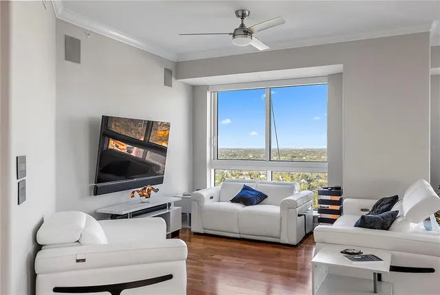 a living room with furniture and floor to ceiling window