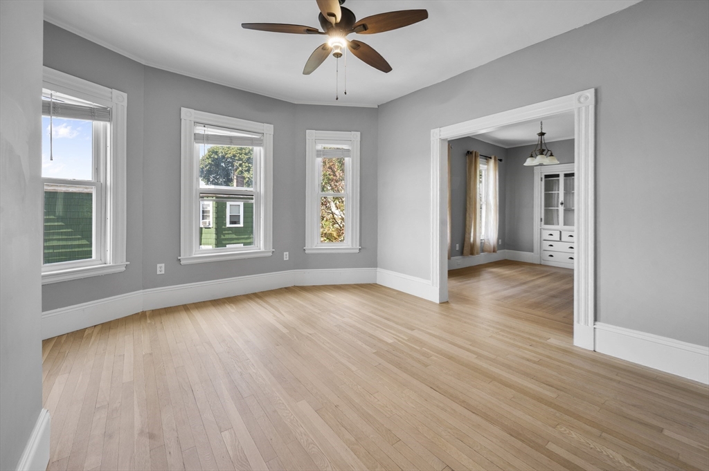43 Robinson Street, Unit 3 Boston, MA 02122 - Photo 13 of 42 an empty room with wooden floor chandelier and windows