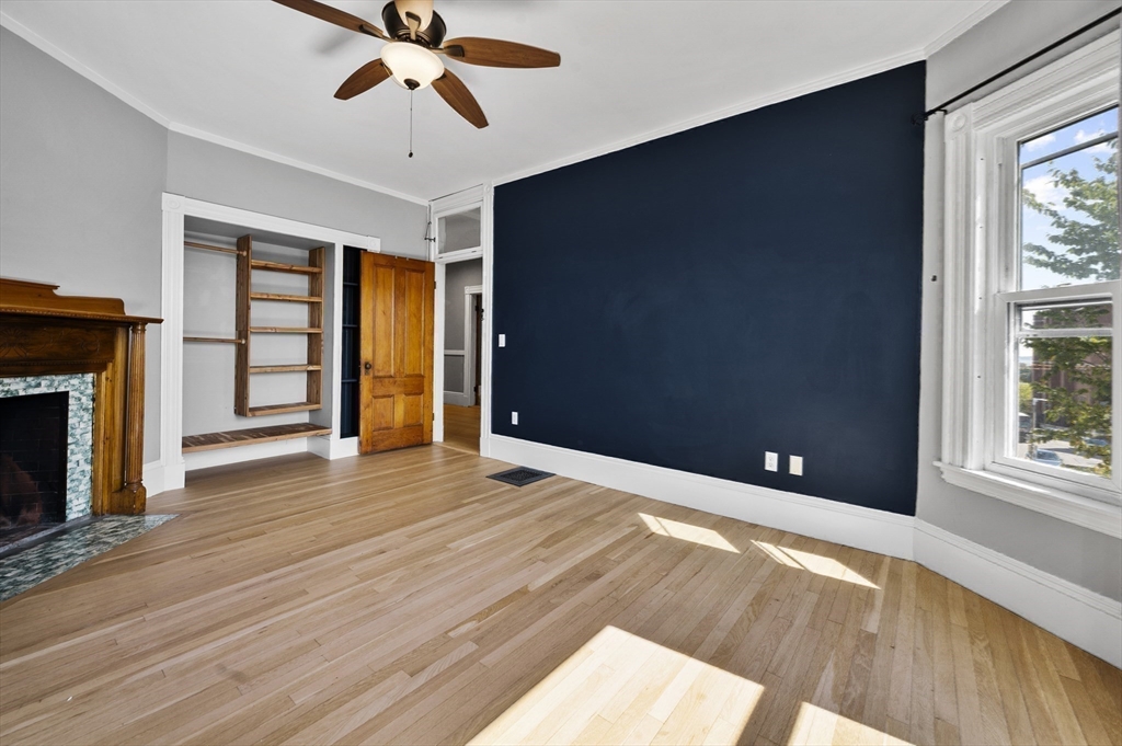 43 Robinson Street, Unit 3 Boston, MA 02122 - Photo 22 of 42 a view of an empty room with a window and wooden floor