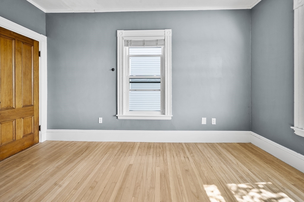 43 Robinson Street, Unit 3 Boston, MA 02122 - Photo 28 of 42 an empty room with wooden floor and windows