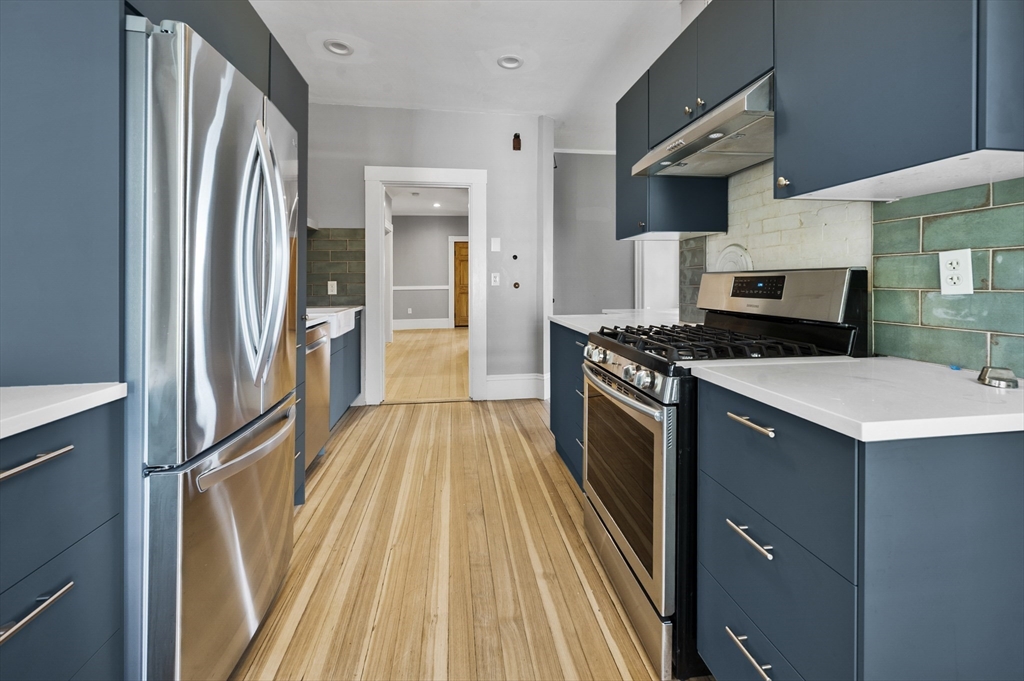 43 Robinson Street, Unit 3 Boston, MA 02122 - Photo 4 of 42 a kitchen with granite countertop a sink a counter top space stainless steel appliances and cabinets