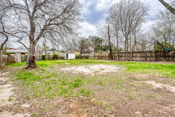 a view of a yard with a house in the background