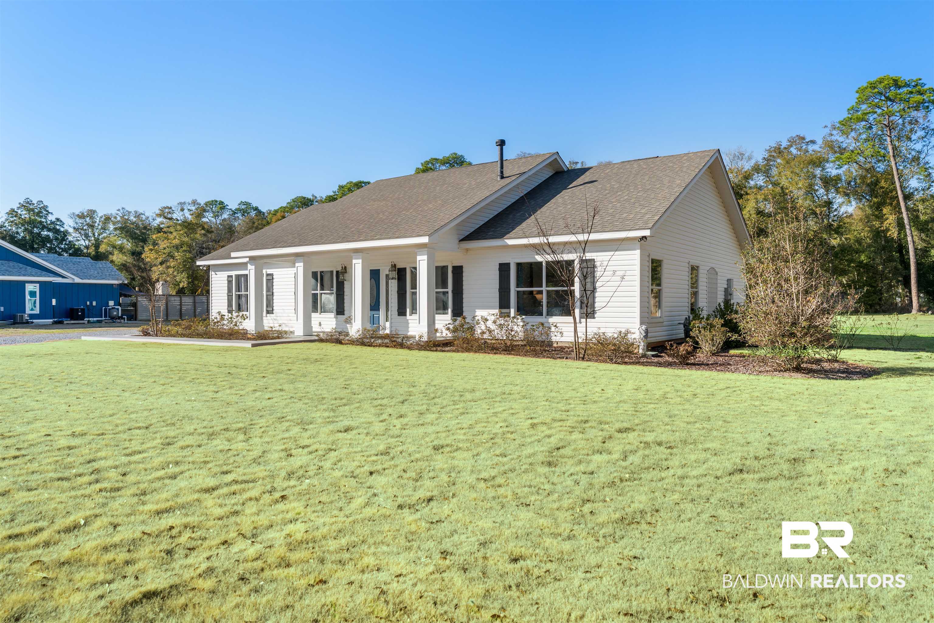 19079 Baldwin County Road 10 Foley, AL 36535 - Photo 36 of 37 Ranch-style house featuring covered porch, a front lawn, and a shingled roof