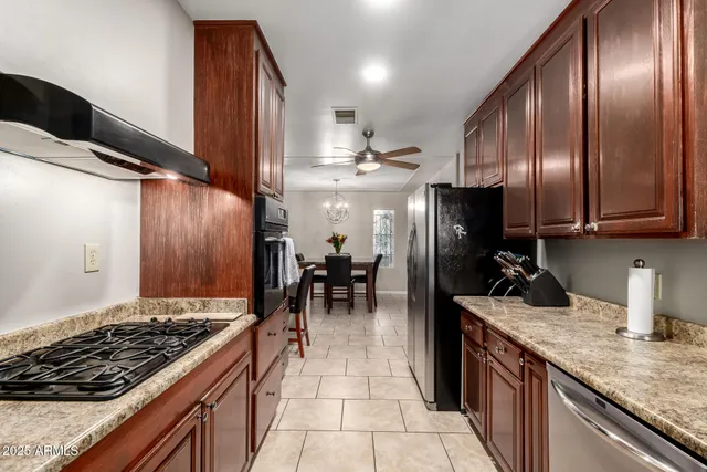 a kitchen with lots of counter top space and stainless steel appliances