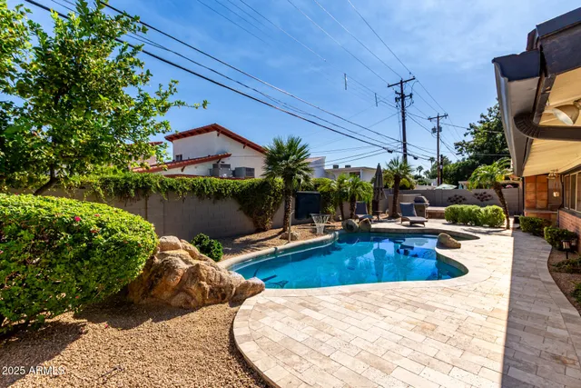 a view of a house with swimming pool and sitting area