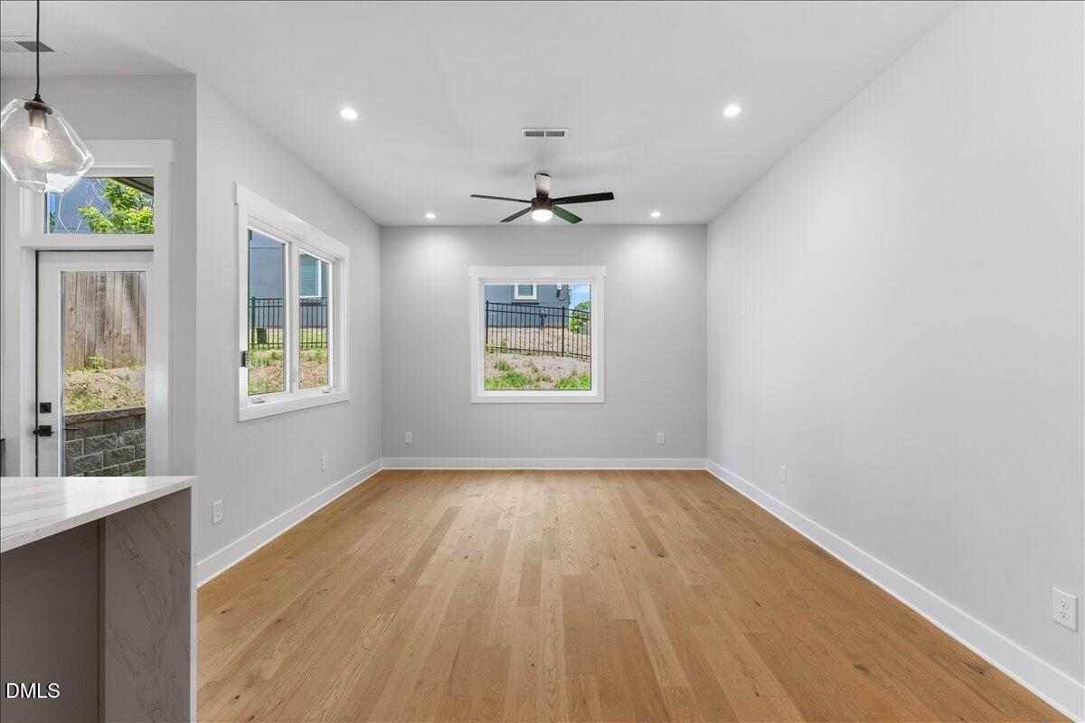541 Bragg Street Raleigh, NC 27601 - Photo 17 of 44 an empty room with windows and ceiling fan