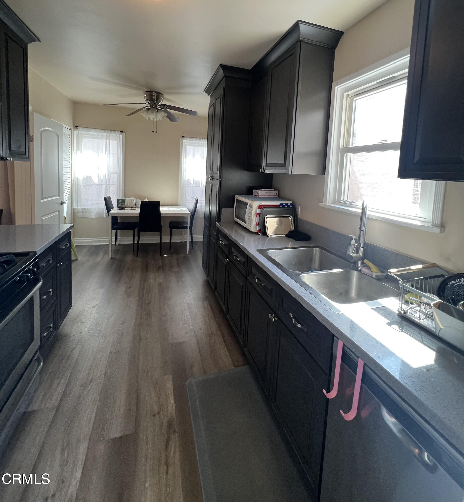 7618 Summitrose Street Tujunga, CA 91042 - Photo 11 of 15 a kitchen with sink stove and cabinets