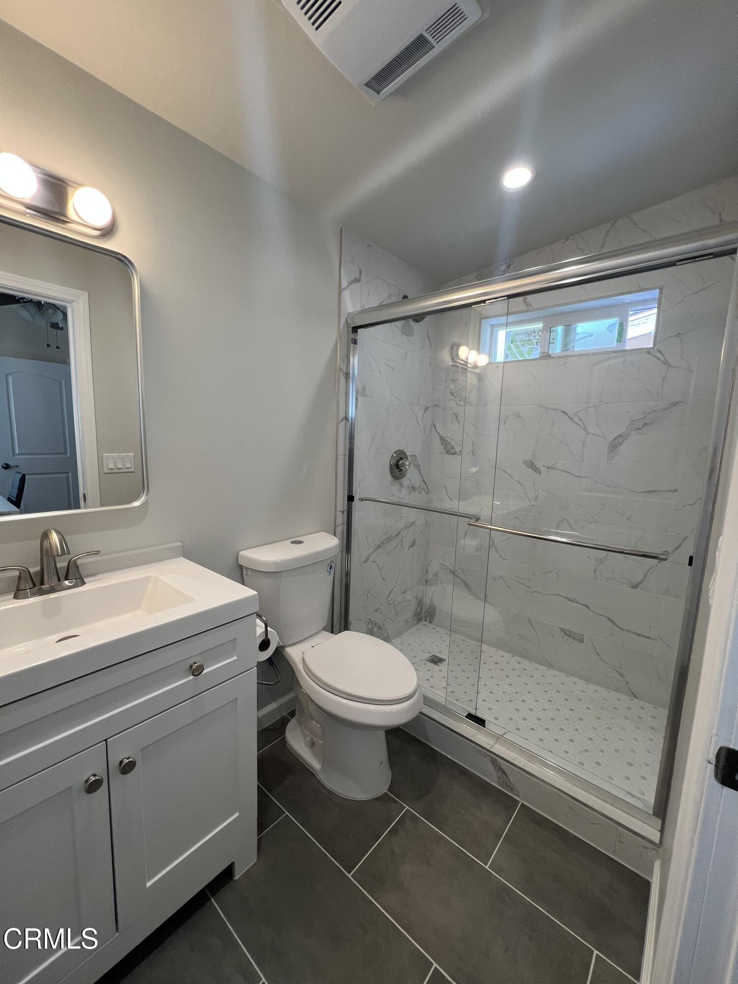 7618 Summitrose Street Tujunga, CA 91042 - Photo 14 of 15 a bathroom with a sink toilet and shower