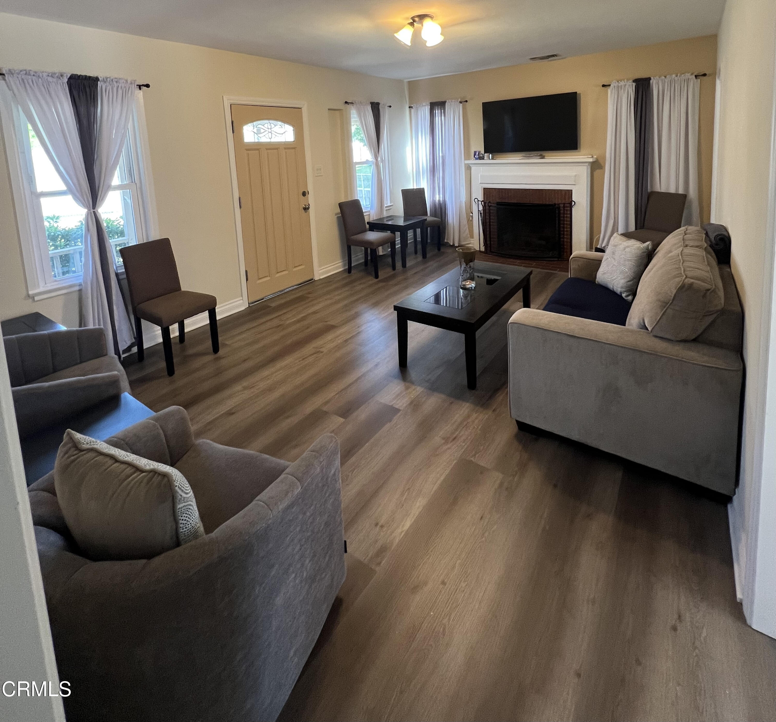 7618 Summitrose Street Tujunga, CA 91042 - Photo 3 of 15 a living room with furniture and a fireplace