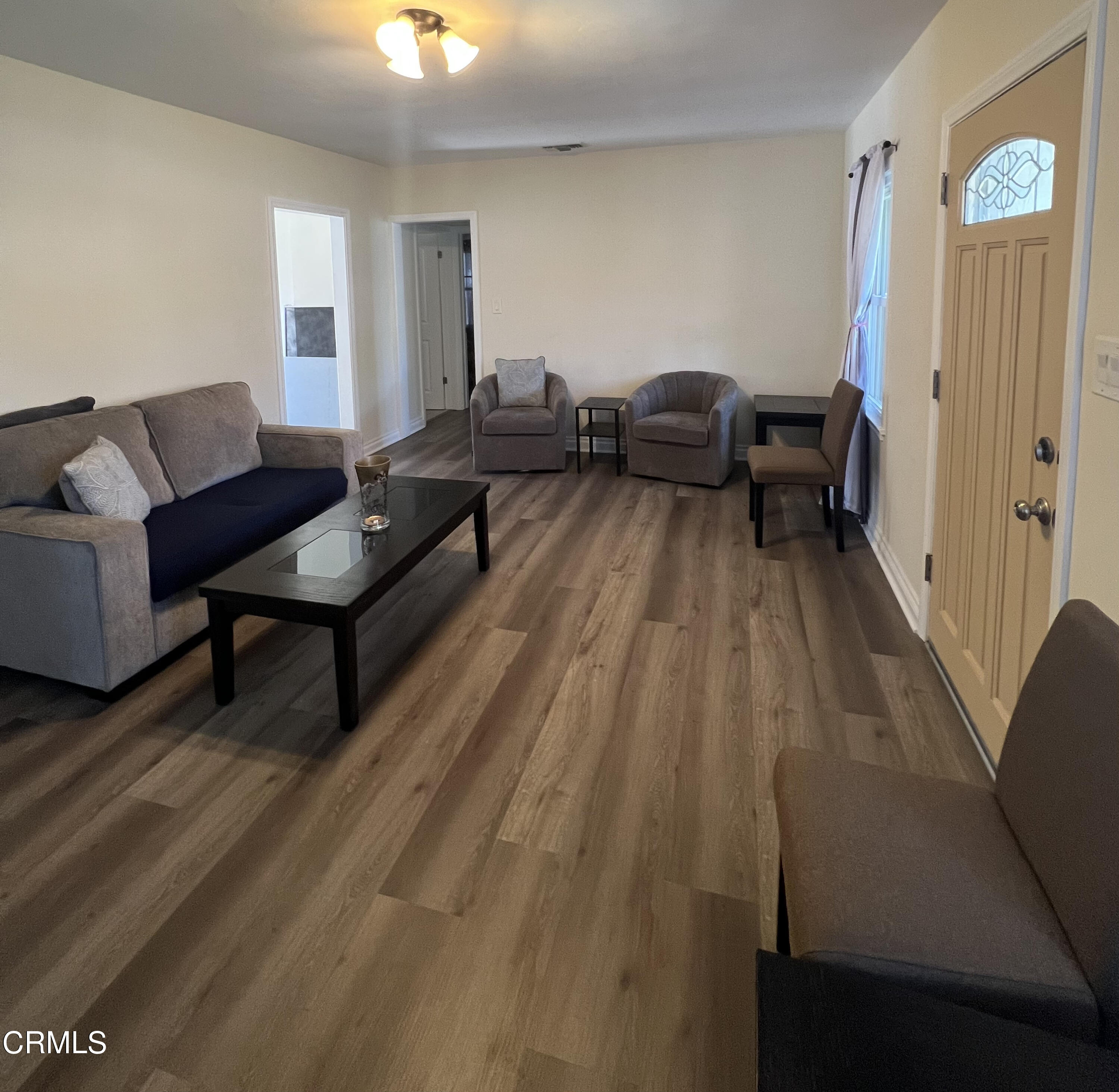 7618 Summitrose Street Tujunga, CA 91042 - Photo 4 of 15 a living room with furniture and a wooden floor