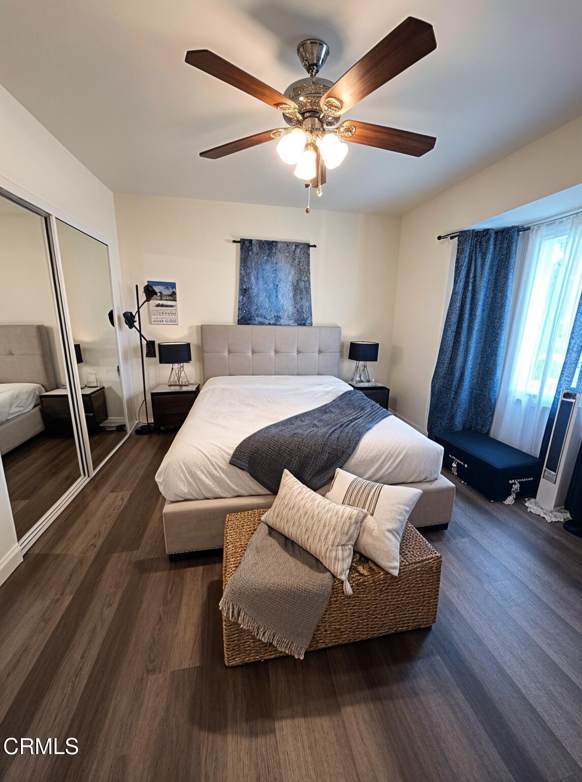 7618 Summitrose Street Tujunga, CA 91042 - Photo 8 of 15 a bedroom with a bed a couch and a chandelier