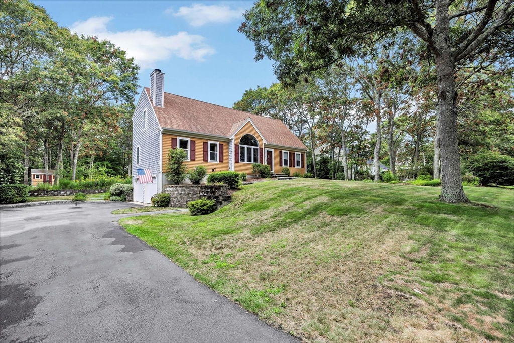 19 Drew Lane Mashpee, MA 02649 - Photo 1 of 42 a front view of a house with a yard