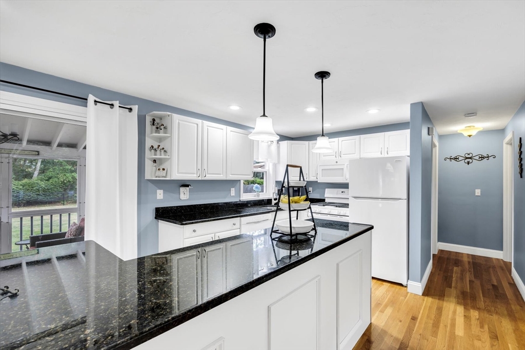 19 Drew Lane Mashpee, MA 02649 - Photo 15 of 42 a kitchen with stainless steel appliances granite countertop a sink a stove and a wooden floors