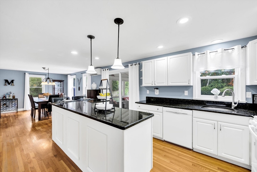 19 Drew Lane Mashpee, MA 02649 - Photo 16 of 42 a kitchen with granite countertop a sink a counter top space and living room view