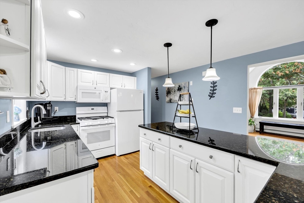 19 Drew Lane Mashpee, MA 02649 - Photo 18 of 42 a kitchen with white cabinets and stainless steel appliances