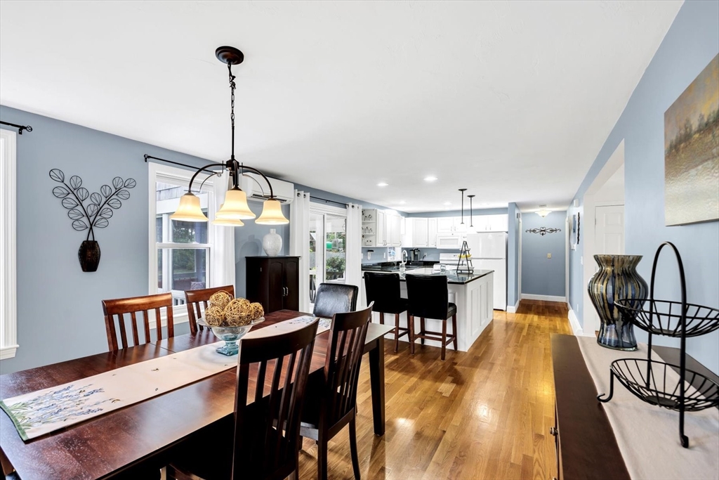 19 Drew Lane Mashpee, MA 02649 - Photo 20 of 42 a view of a dining room and livingroom with furniture wooden floor a chandelier
