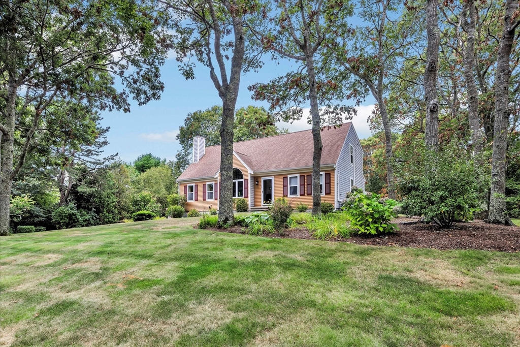 19 Drew Lane Mashpee, MA 02649 - Photo 2 of 42 a front view of a house with a garden