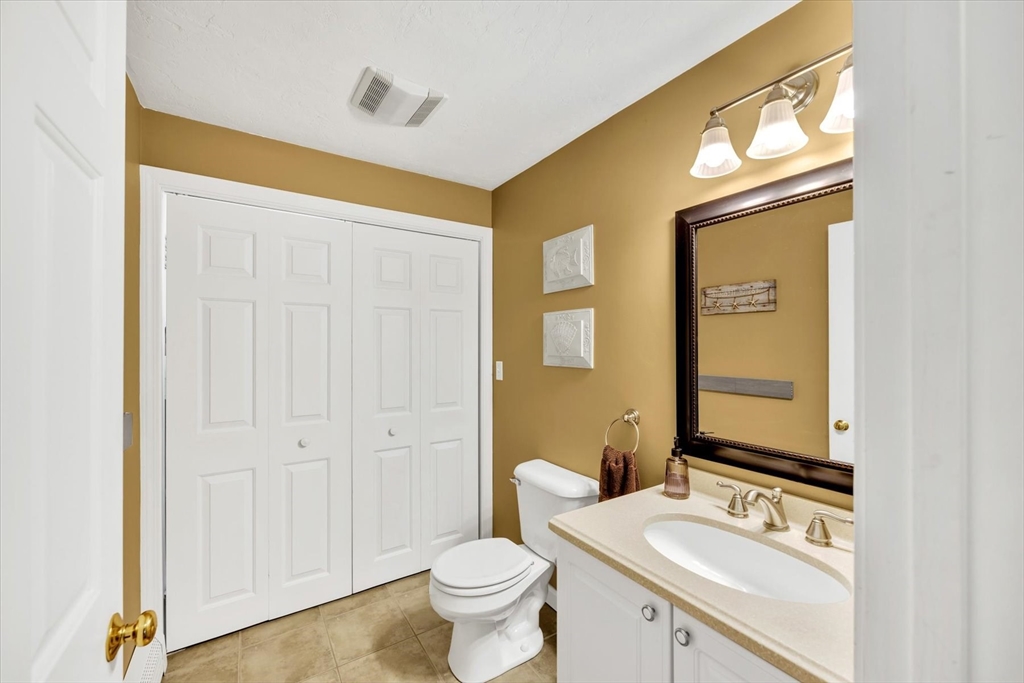 19 Drew Lane Mashpee, MA 02649 - Photo 21 of 42 a bathroom with a sink a toilet and a mirror