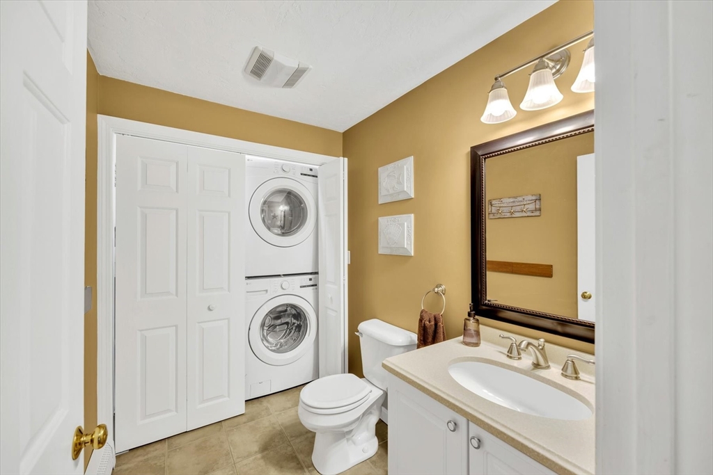 19 Drew Lane Mashpee, MA 02649 - Photo 22 of 42 a bathroom with a sink a toilet and a mirror