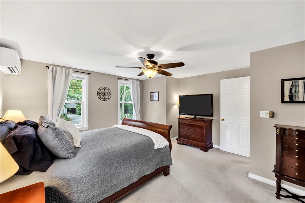 19 Drew Lane Mashpee, MA 02649 - Photo 25 of 42 a bedroom with a bed and a flat screen tv