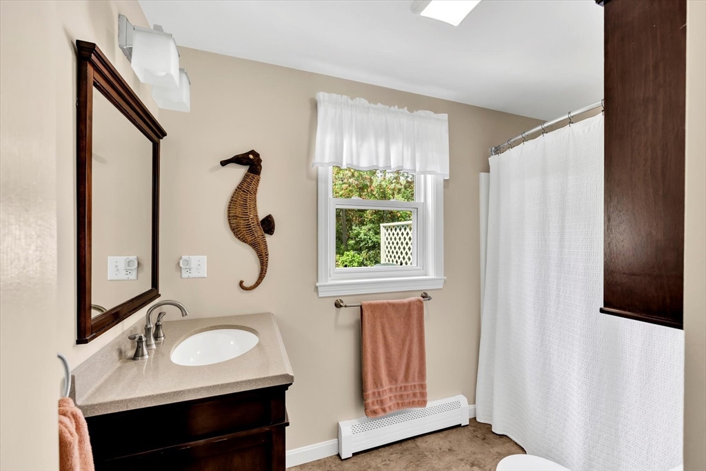 19 Drew Lane Mashpee, MA 02649 - Photo 27 of 42 a bathroom with a sink and a mirror