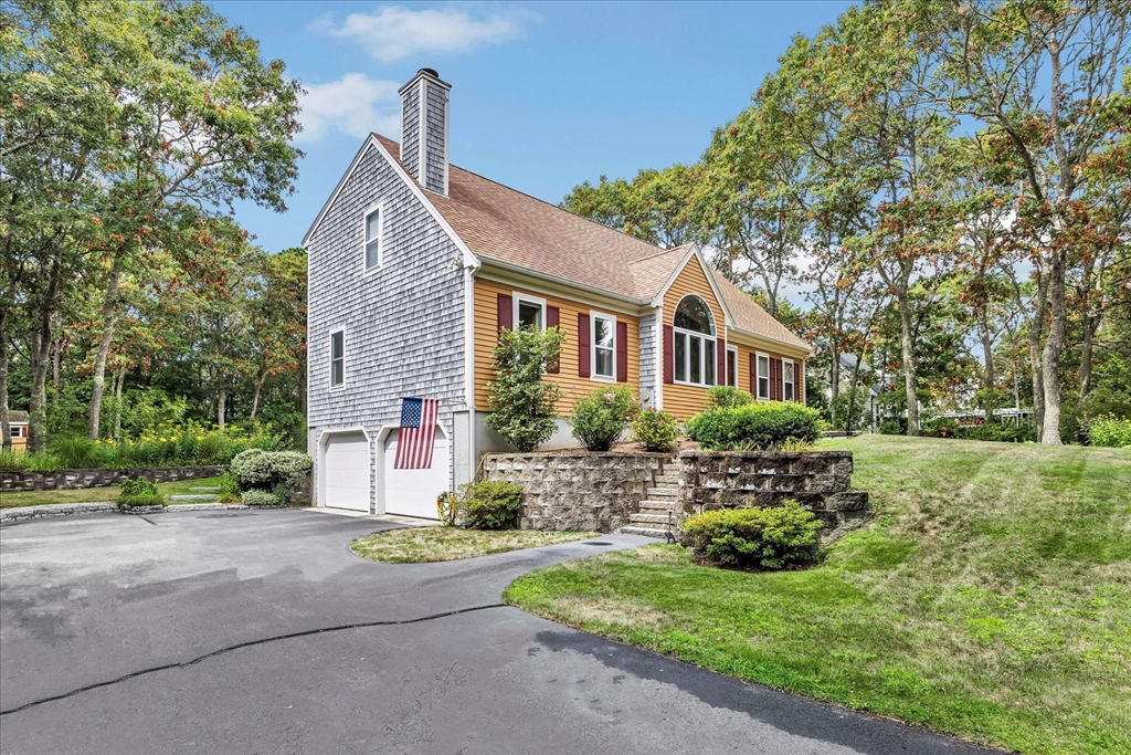 19 Drew Lane Mashpee, MA 02649 - Photo 3 of 42 a front view of a house with a yard