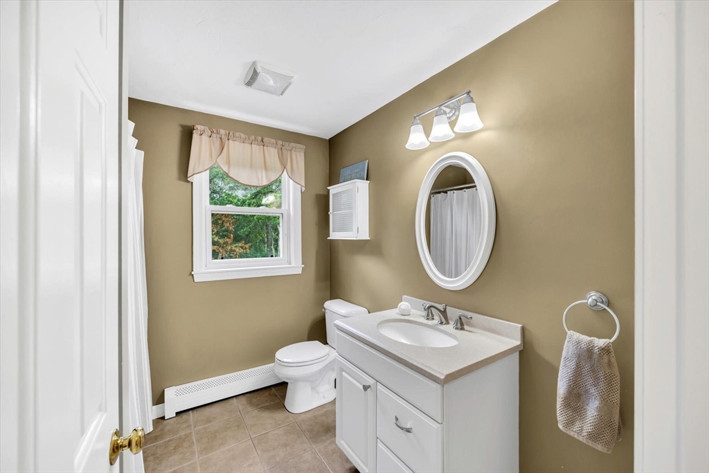 19 Drew Lane Mashpee, MA 02649 - Photo 33 of 42 a bathroom with a toilet sink and mirror