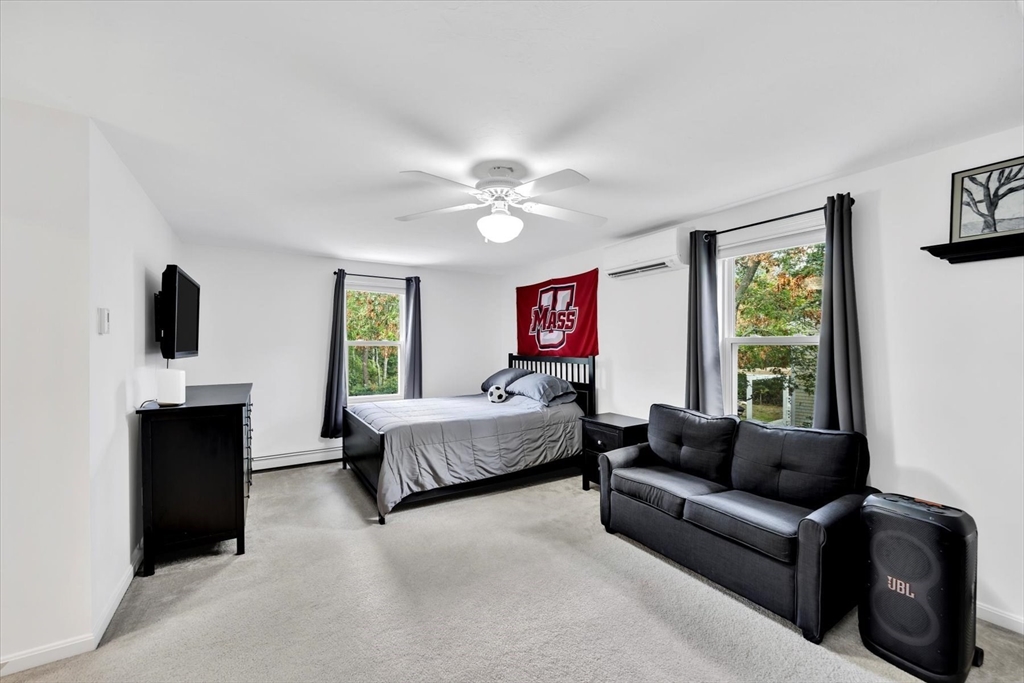 19 Drew Lane Mashpee, MA 02649 - Photo 35 of 42 a living room with furniture ceiling fan and a window