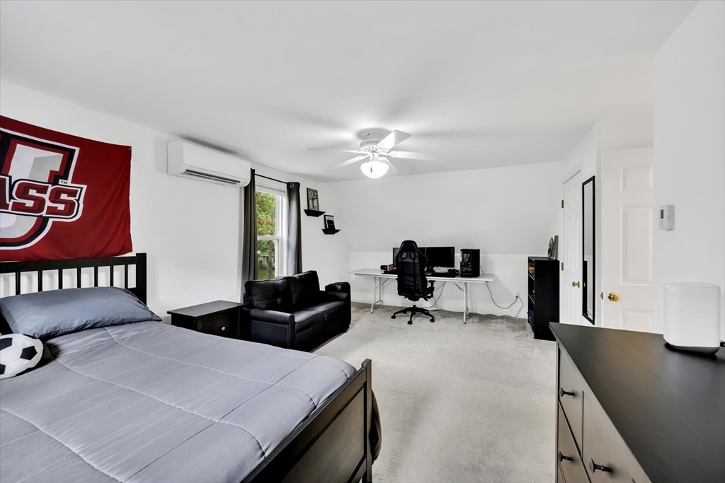 19 Drew Lane Mashpee, MA 02649 - Photo 37 of 42 a bedroom with a bed a couch and a large window