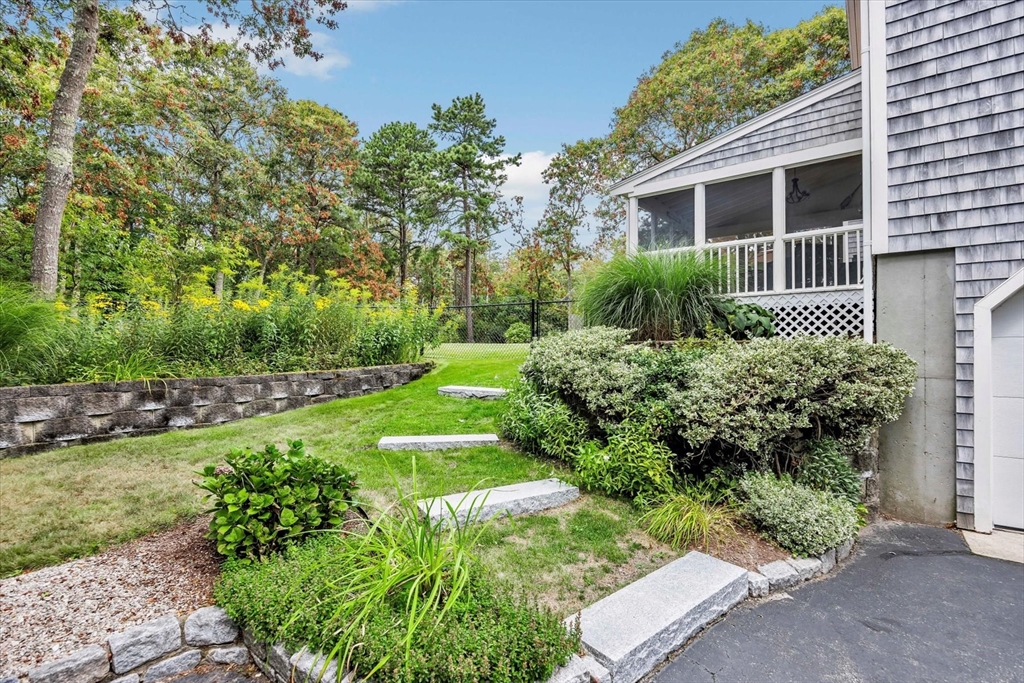 19 Drew Lane Mashpee, MA 02649 - Photo 4 of 42 a view of backyard with a garden and plants