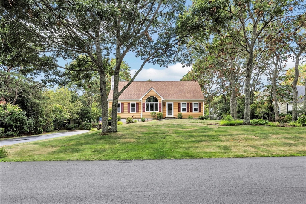 19 Drew Lane Mashpee, MA 02649 - Photo 42 of 42 a front view of a house with a yard and garage